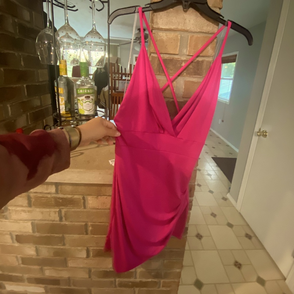 Magenta strappy, assymetrical dress.
